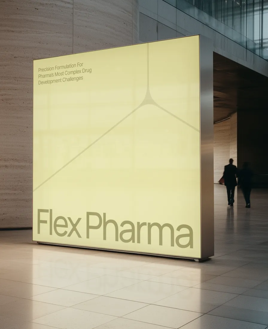 Flex Pharma backlit yellow sign in a stone office lobby, with two people walking past
