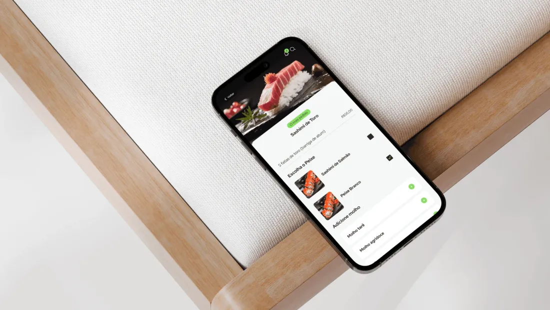Prattu app on a phone resting on a wooden bench, a restaurant menu on screen